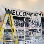 Addison Oberg (left), with the Trail Museum and Archives, and Alison Holm of the Trail and District Public Library put the finishing touches on a welcome banner at the Riverfront Centre as Trail and Rossland prepare for tonight&rsquo;s Opening Ceremony of the Trail-Rossland 2026 BC Winter Games, Thursday, Feb. 26. Games guests are encouraged to stop by the Riverfront Centre, home to the Visitor Information Centre, and explore the history-rich sports gallery on the main floor. Hours are 9:30 a.m. to 7 p.m. Thursday, 9:30 a.m. to 5 p.m. Friday and 9:30 a.m. to 4 p.m. Saturday. The centre is closed Sunday. (Sheri Regnier/Trail Times)